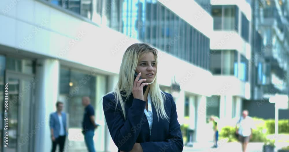 Young business woman talking on the cellphone in modern, urban environment. Young business woman talking on the cellphone in modern, urban environment.