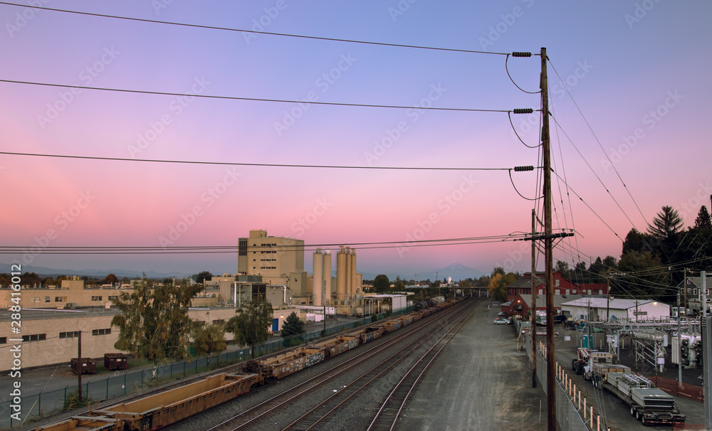 Power lines and rail road tracks looking east at sunset in North Portland, Oregon
