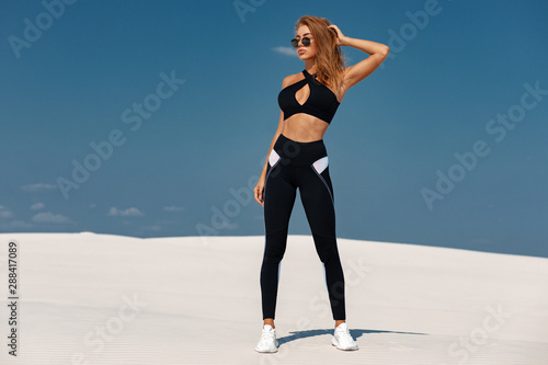 Beautiful fitness woman outdoors. Athletic girl in leggings Stock