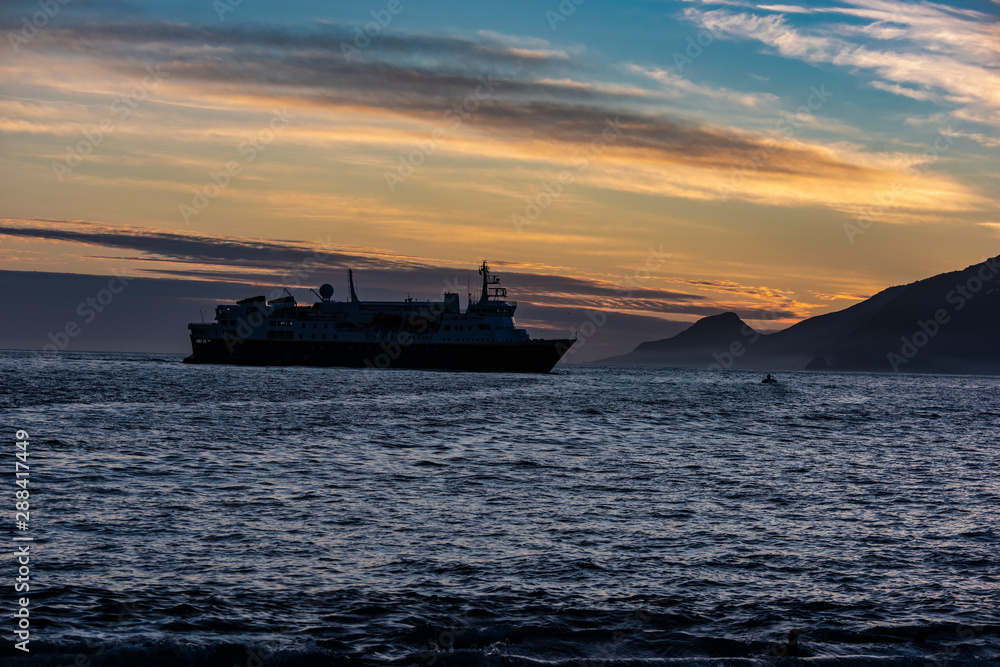 Fototapeta premium Ship in Antarctica at sunrise