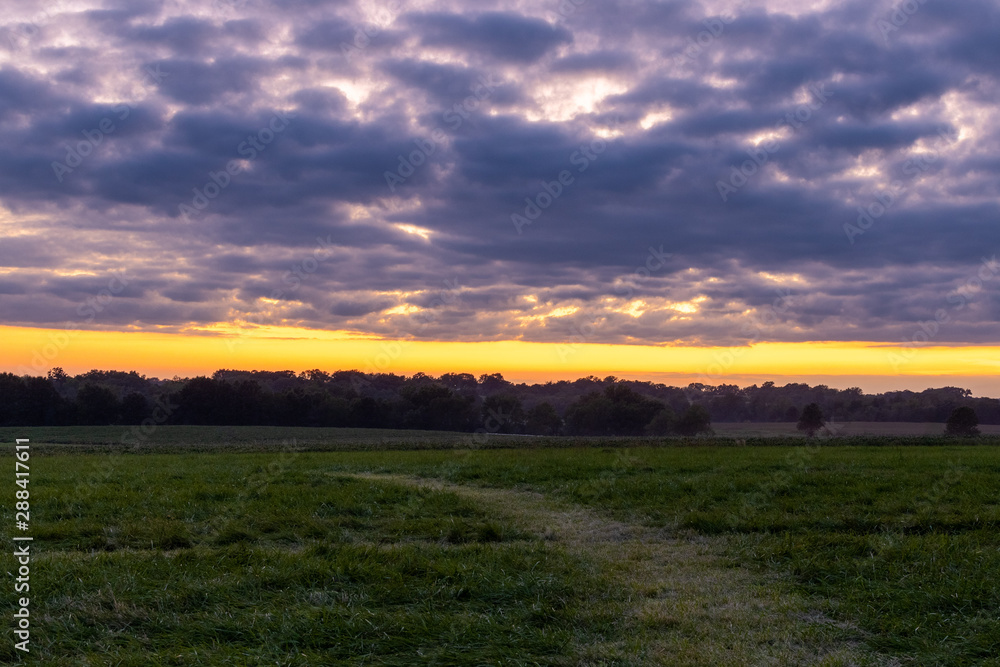 sunset over green field sunset over green field