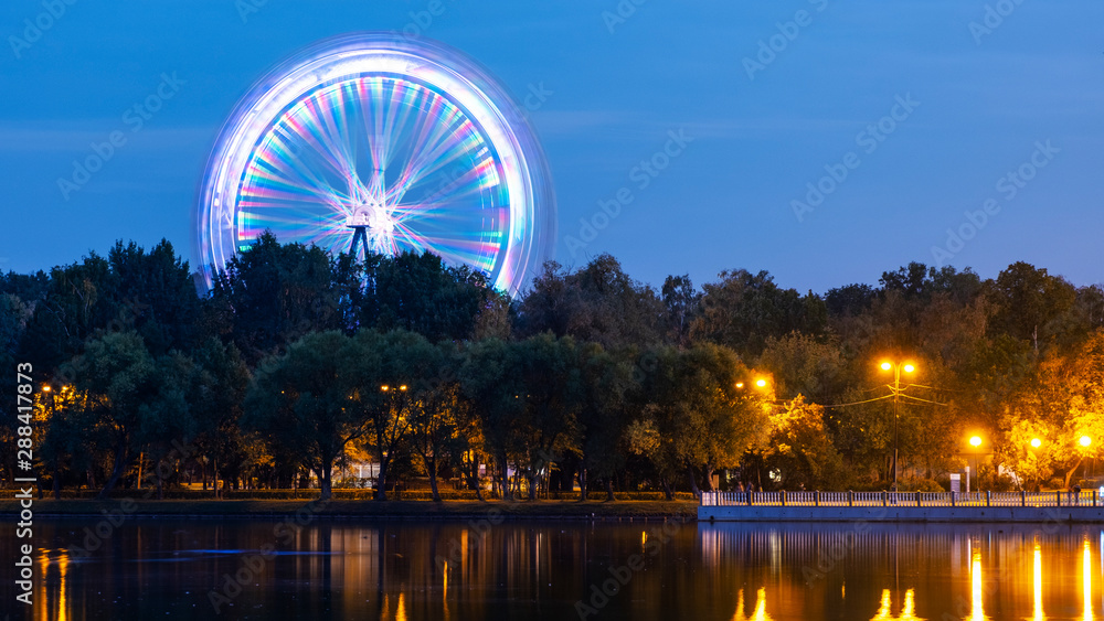 Ferris wheel in the park next to the pond