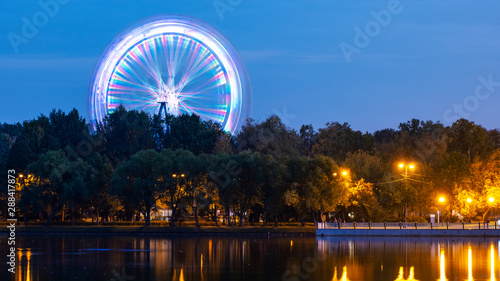 Ferris wheel in the park next to the pond