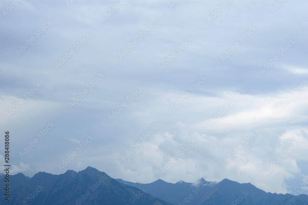 Düstere graue Regenwolken über den Alpen