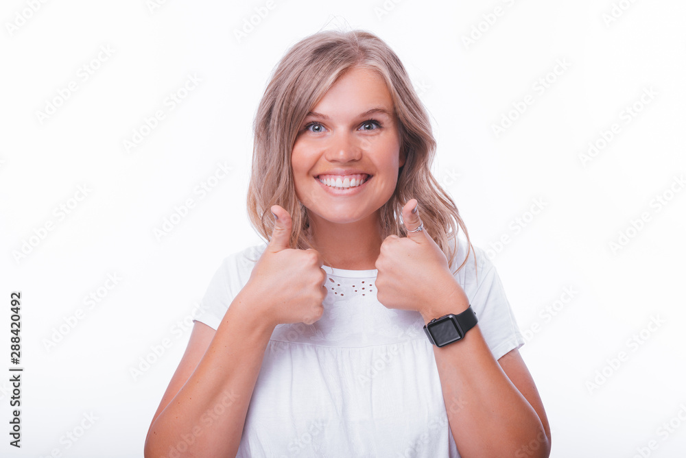Photo of cheerful woman, showing thumbs up over isolated background Photo of cheerful woman, showing thumbs up over isolated background
