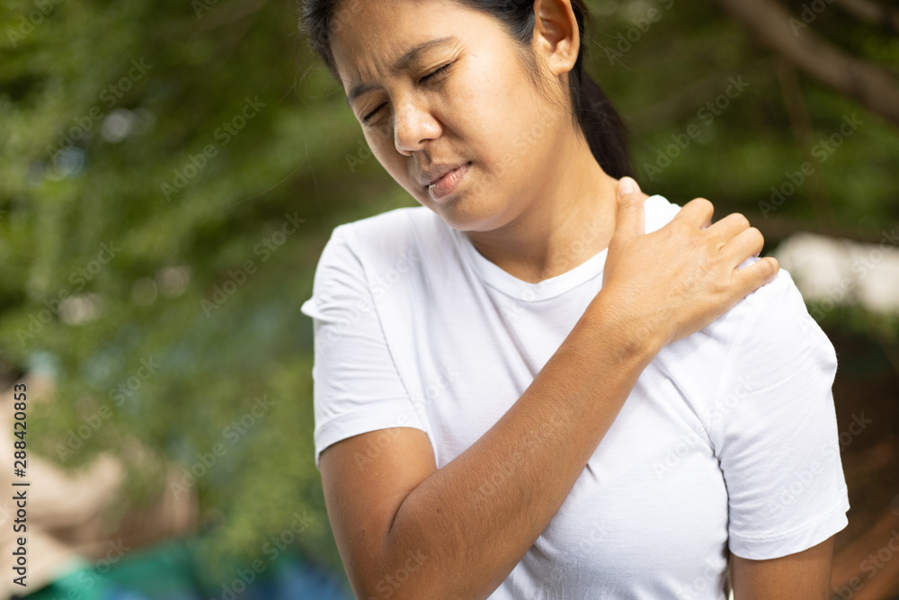Young asian woman has pain in shoulder , health care concept Young asian woman has pain in shoulder , health care concept