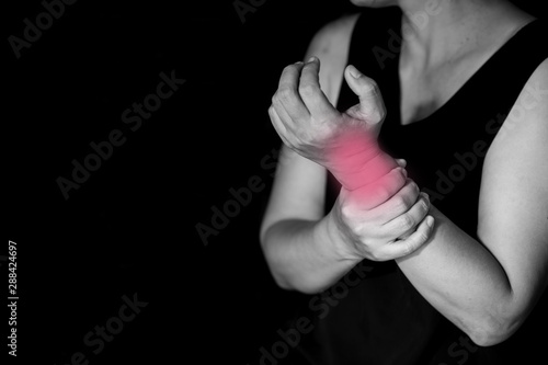 Closeup woman suffering from pain in wrist