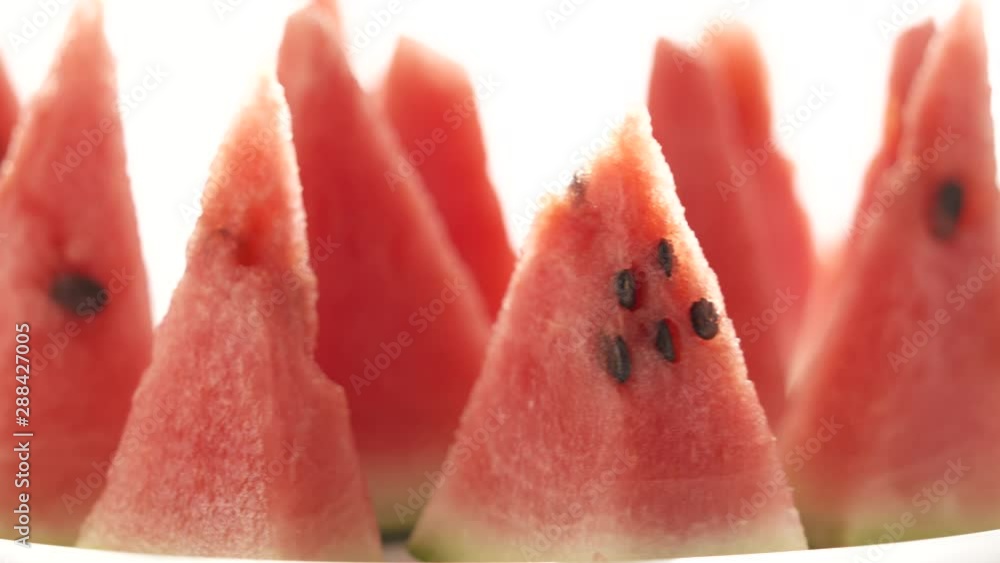 Watermelon mini wedges rotating on white background. Watermelon mini wedges rotating on white background.