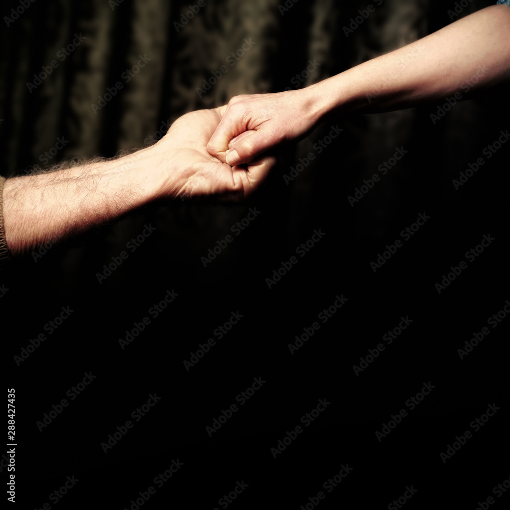 close up senior adult male hand and young adult female hand holding each other