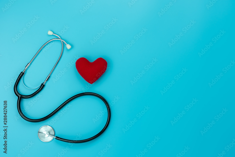Table top view aerial image of accessories healthcare & medical background concept.Red heart & stethoscope with essential objects on blue paper.Flat lay of idea for doctor treat patient in hospital. Table top view aerial image of accessories healthcare & medical background concept.Red heart & stethoscope with essential objects on blue paper.Flat lay of idea for doctor treat patient in hospital.