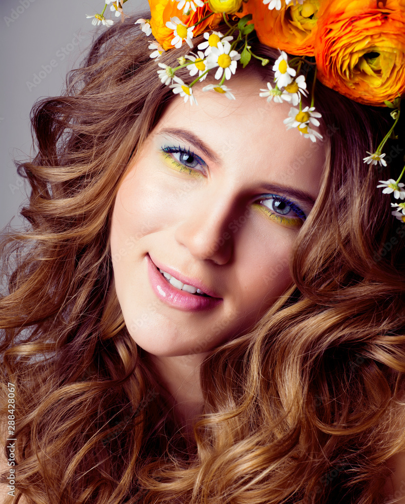 Fototapeta premium Beauty young woman with flowers and make up close up, real spring beauty