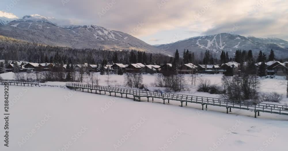 Woman Cross Country Skiing In Frozen Landscape At Sunset Woman Cross Country Skiing In Frozen Landscape At Sunset