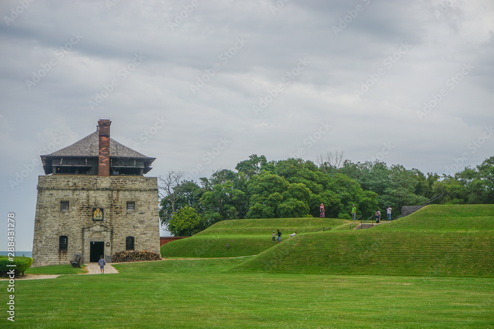 Fototapeta premium Porter, New York, USA: Visitors at the North Redoubt on the 23-acre grounds of Old Fort Niagara, on a cloudy day on Lake Ontario.