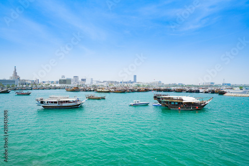 Boats in harbor Doha with turquoise Persian Gulf water Qatar.