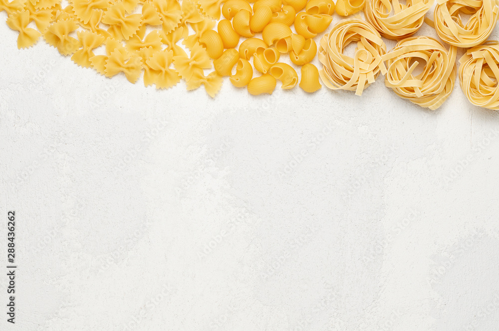 Different types of Italian pasta. Farfalle, Pipe rigate and Fettuccine on light grey background
