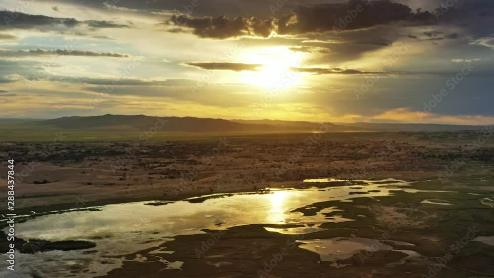 Aerial view of the sand dunes Elsen Tasarhai (Bayan Gobi) and lake at sunset in Mongolia, 4k Aerial view of the sand dunes Elsen Tasarhai (Bayan Gobi) and lake at sunset in Mongolia, 4k