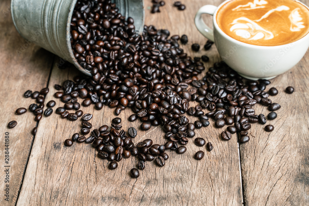 Latte art coffee cup with coffee bean on wood table Latte art coffee cup with coffee bean on wood table