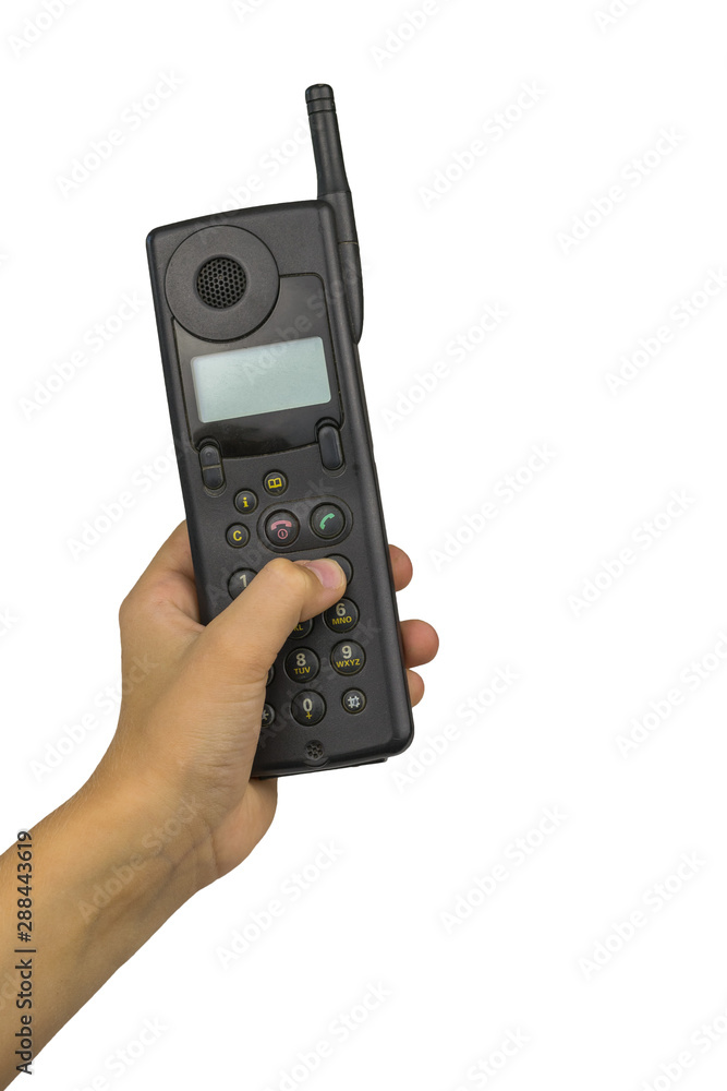 Retro mobile phone in baby's hand isolated on white background. Retro means of communication. Retro mobile phone in baby's hand isolated on white background. Retro means of communication.