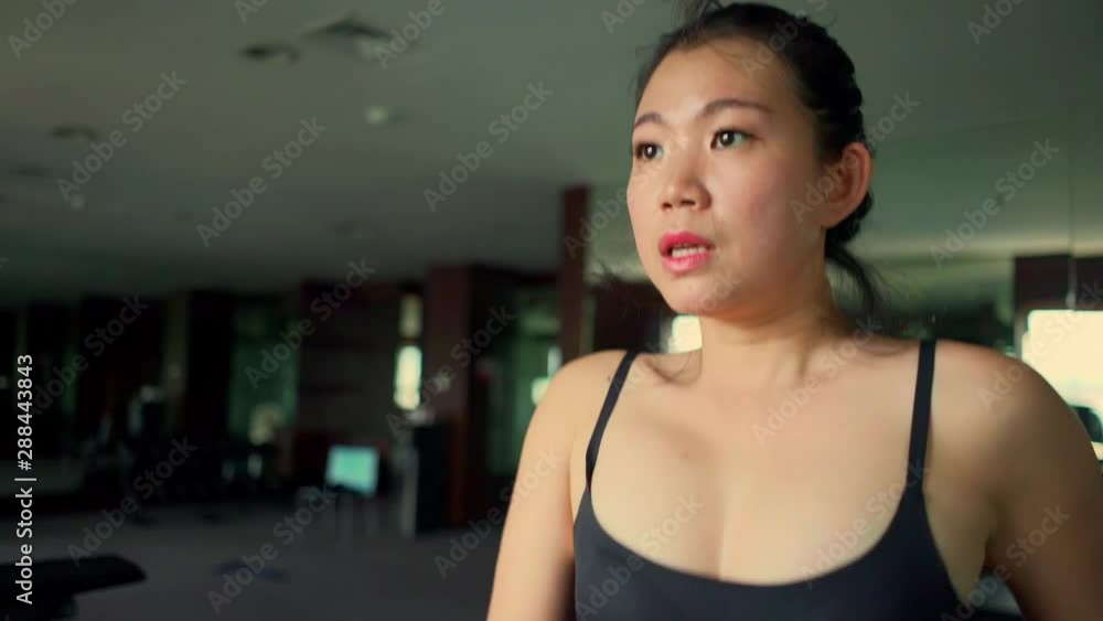 young attractive and cute Asian Korean woman doing running workout at hotel gym or fitness club jogging in treadmill training hard in healthy lifestyle and body care concept young attractive and cute Asian Korean woman doing running workout at hotel gym or fitness club jogging in treadmill training hard in healthy lifestyle and body care concept
