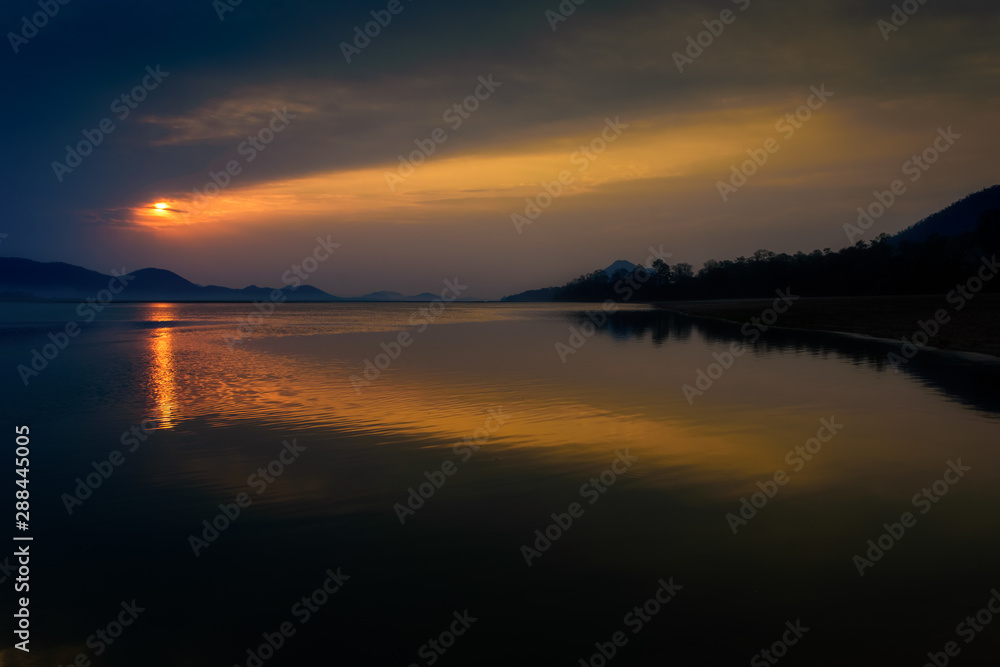 Obraz premium Sunrise over Mahanadi river, Odisha, Eastern Ghat mountain range, copy space