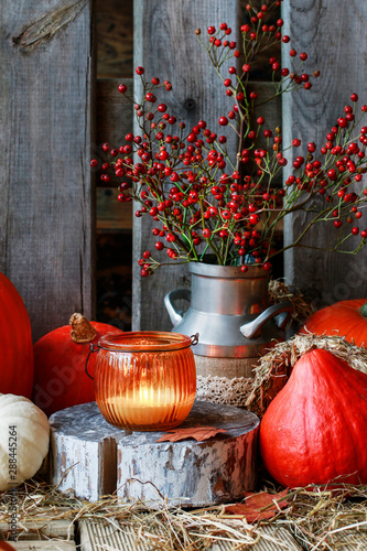 Autumn decorations with pumpkins, hay, leaves and beautiful lanterns.