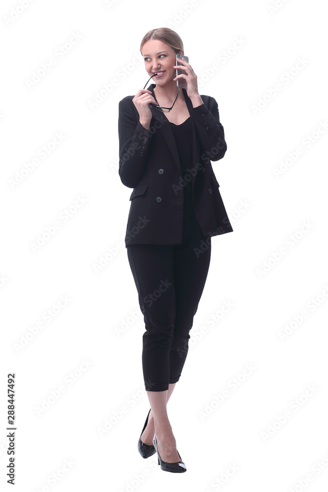 in full growth. smiling businesswoman talking on a smartphone in full growth. smiling businesswoman talking on a smartphone