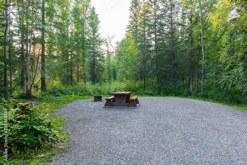 Fényképezés Empty campsite with picnic table in Liard River Hot Springs Provincial Park, Bri