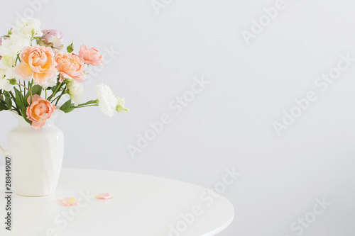 beautiful roses in ceramic white jug