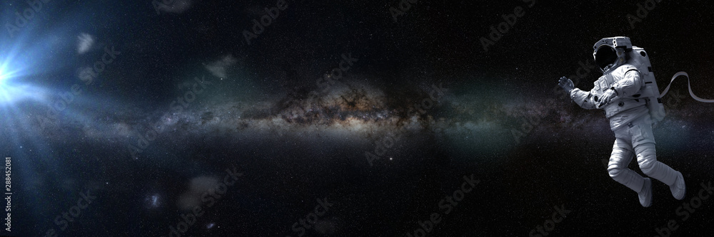 astronaut in empty space in front of the Milky Way galaxy
