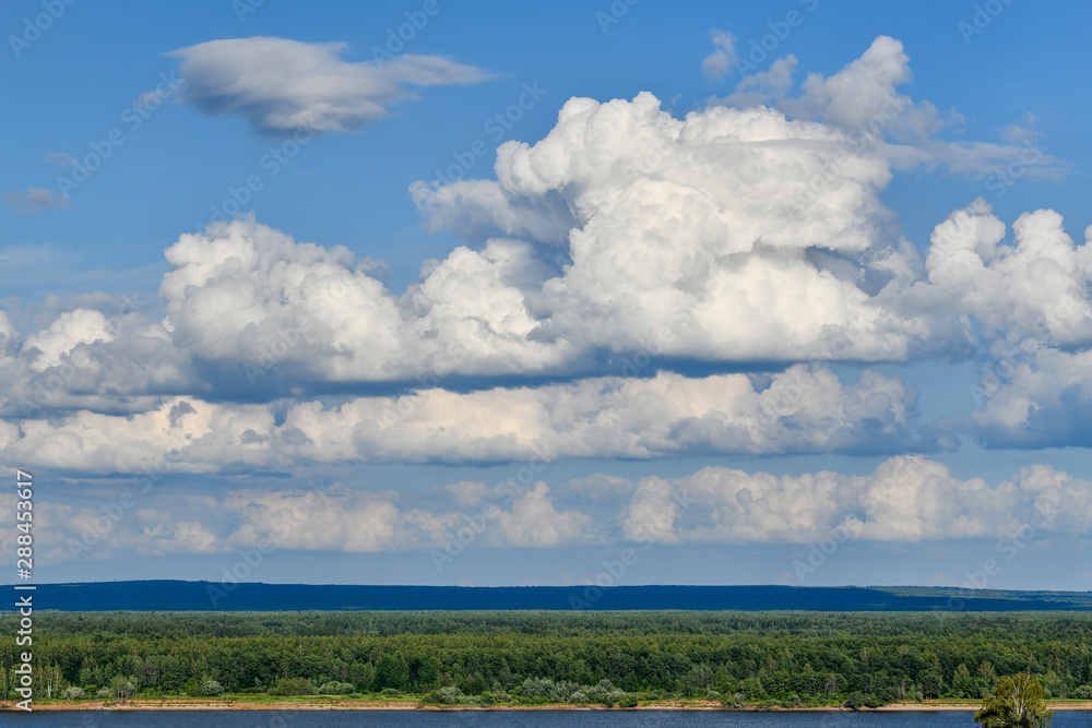 Beautiful cumulus clouds over the river and forest. Beautiful cumulus clouds over the river and forest.