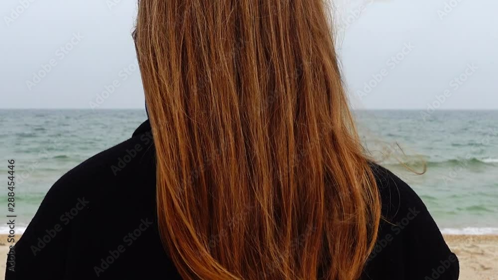 The girl looks at the sea. Shooting on the beach. The girl looks at the sea. Shooting on the beach.