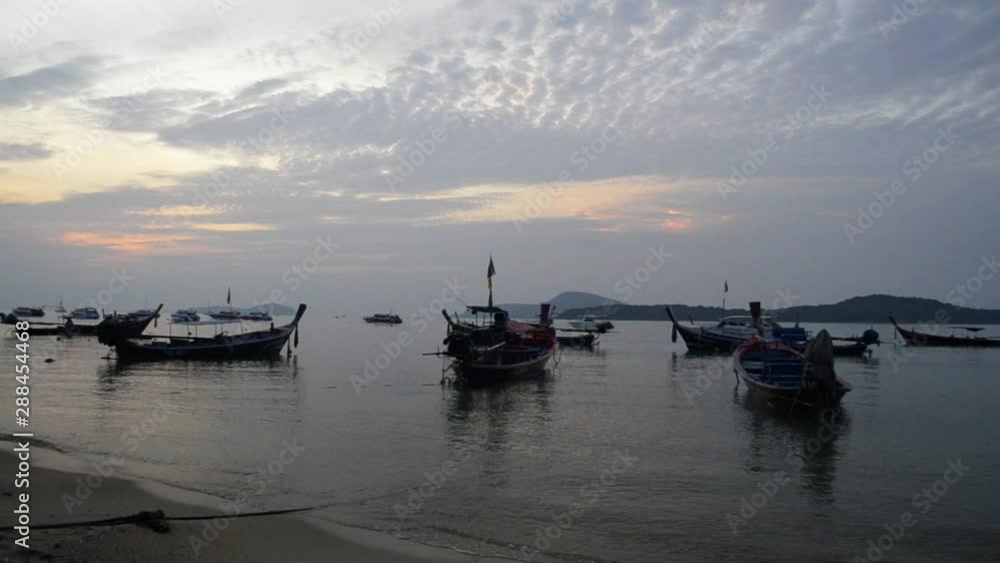 Scenery of Rawai beach during sunrise with many long tail boat in the andaman sea, Phuket, Thailand. Scenery of Rawai beach during sunrise with many long tail boat in the andaman sea, Phuket, Thailand.