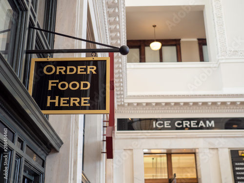 Order food here and ice cream sign posts hanging