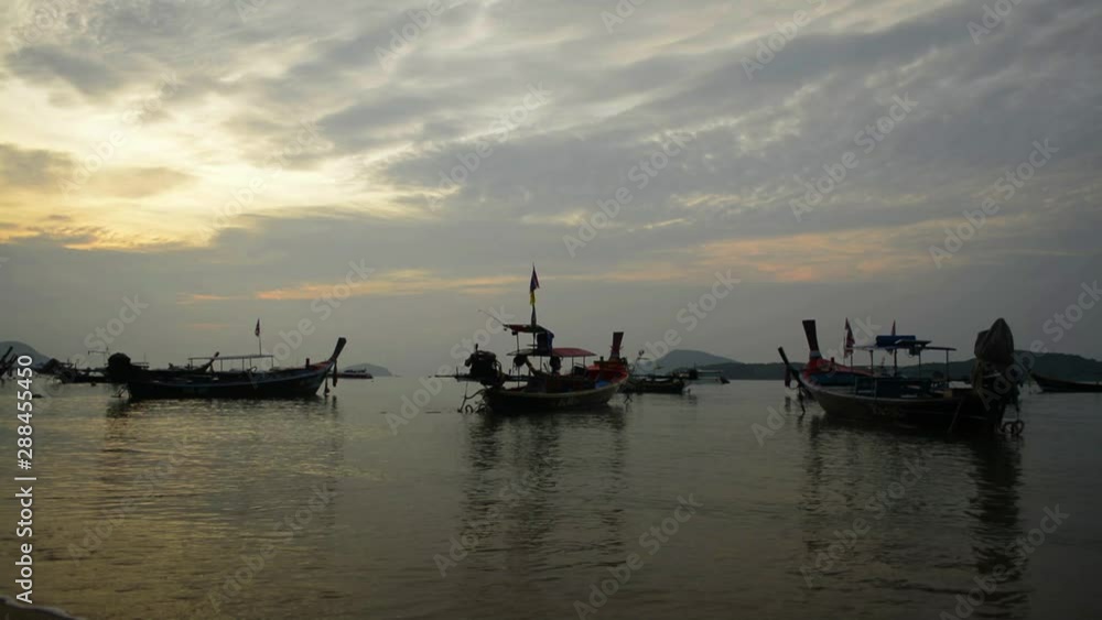 Scenery of Rawai beach during sunrise with many long tail boat in the andaman sea, Phuket, Thailand. Scenery of Rawai beach during sunrise with many long tail boat in the andaman sea, Phuket, Thailand.