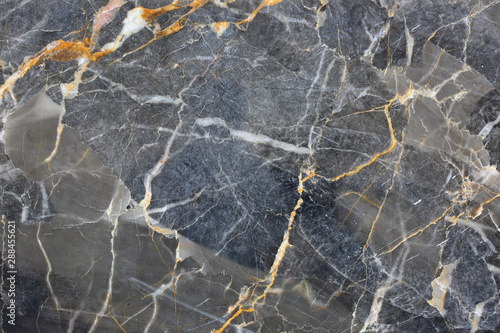 Dark gray marble have pattern color gold yellow caused by nature. Abstract marble background.