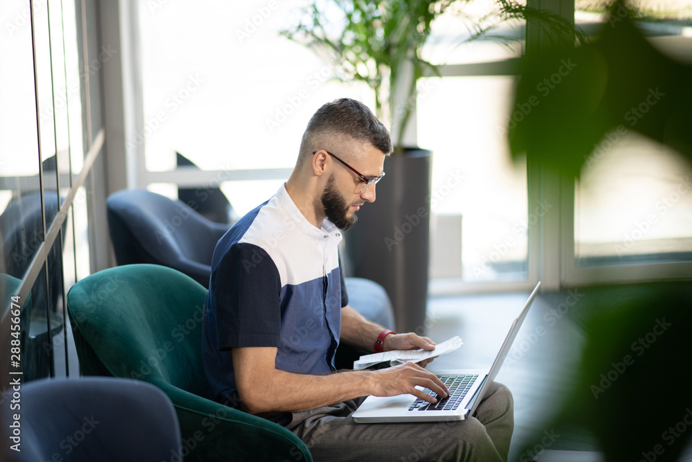 Young businessman working on laptop doing accounting Young businessman working on laptop doing accounting