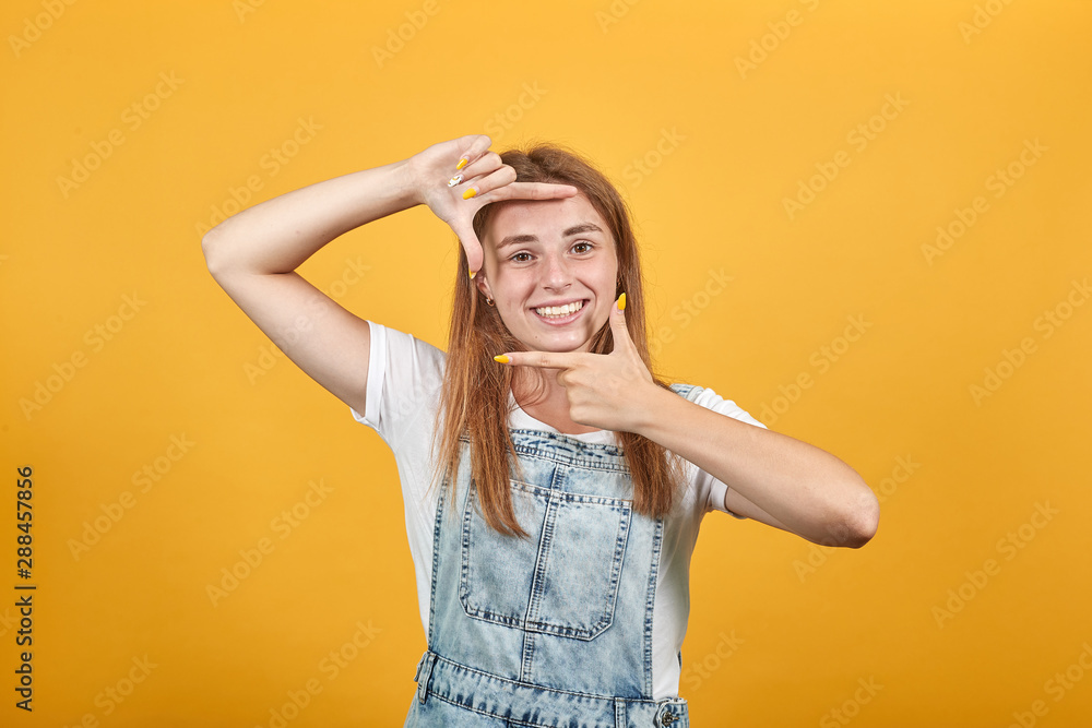 Young woman wearing white t-shirt, over orange background shows emotions Young woman wearing white t-shirt, over orange background shows emotions