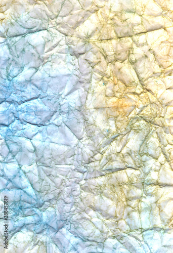 Blue, yellow and brown crumpled paper. Wrinkled background. Sandy beige and sea blue abstract wallpaper. Colorful craft page.