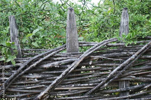 wicker crooked rural fence, country fence in mountains