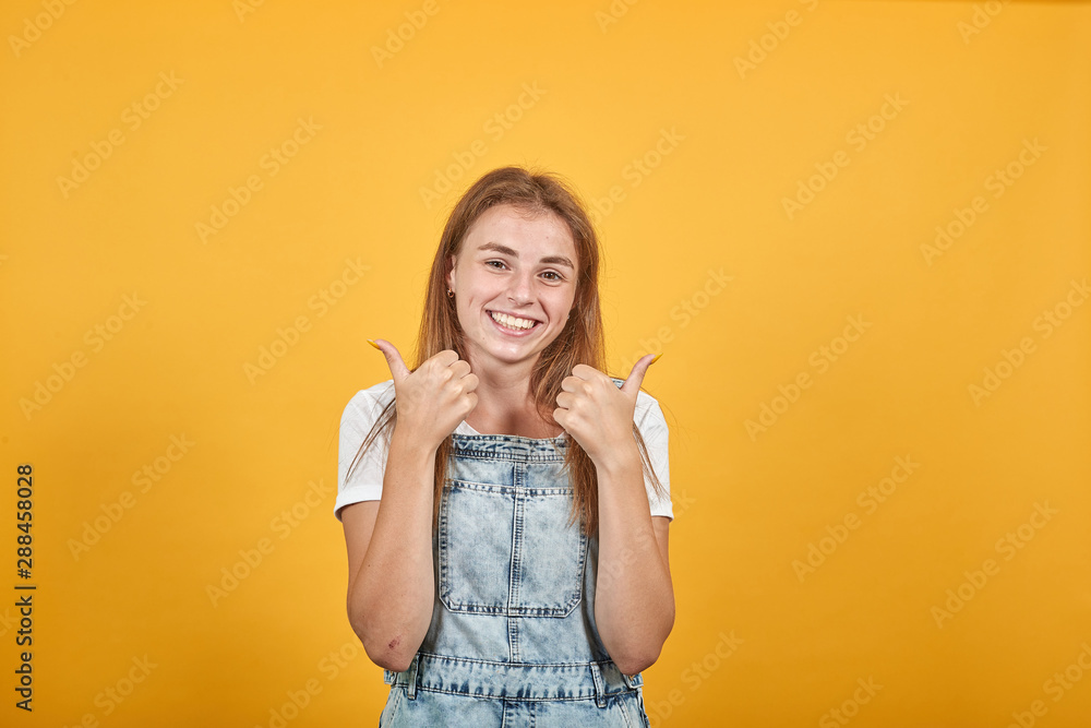 Young woman wearing white t-shirt, over orange background shows emotions Young woman wearing white t-shirt, over orange background shows emotions
