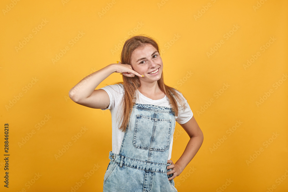 Young woman wearing white t-shirt, over orange background shows emotions Young woman wearing white t-shirt, over orange background shows emotions