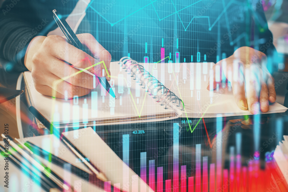 Forex chart hologram on hand taking notes background. Concept of analysis. Multi exposure Forex chart hologram on hand taking notes background. Concept of analysis. Multi exposure