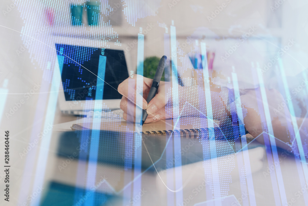 Financial graph displayed on woman's hand taking notes background. Concept of research. Double exposure Financial graph displayed on woman's hand taking notes background. Concept of research. Double exposure