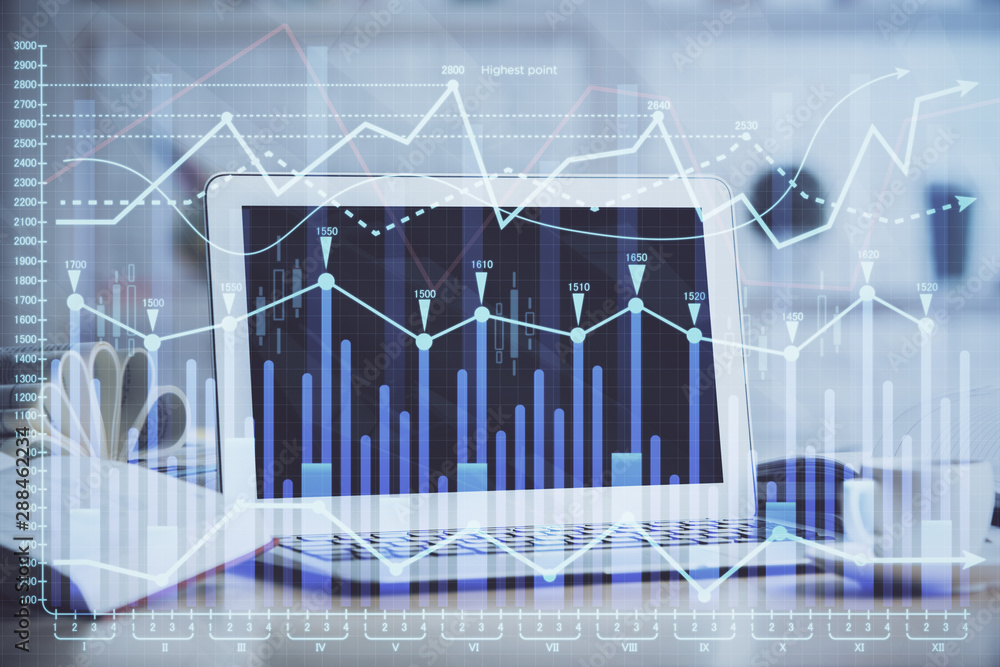 Stock market chart hologram drawn on personal computer background. Multi exposure. Concept of investment. Stock market chart hologram drawn on personal computer background. Multi exposure. Concept of investment.