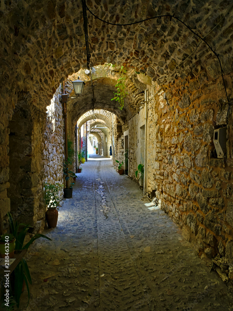 Fototapeta premium Narrow alley at the medieval castle village of Mesta in Chios island , Greece.