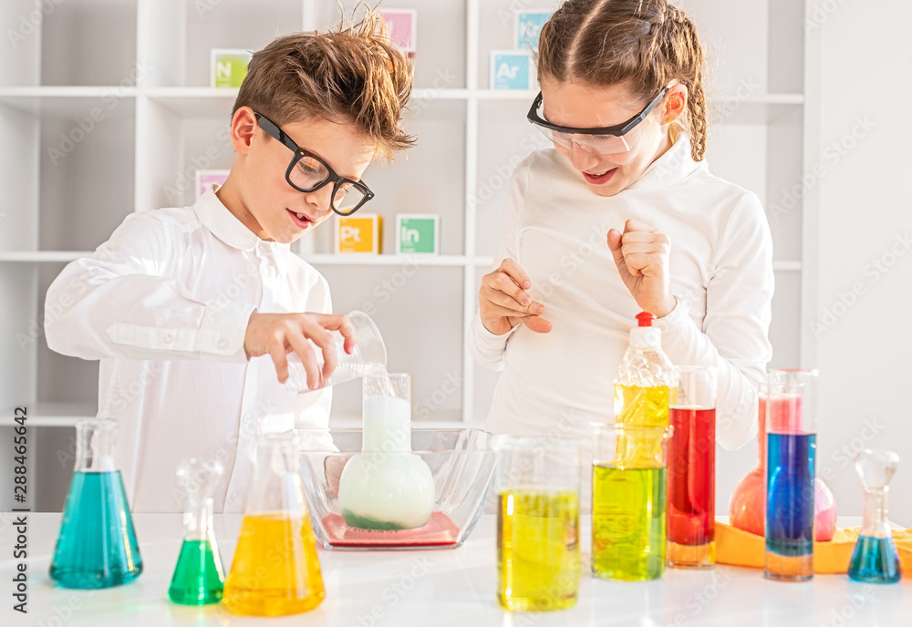 Children mixing chemical substances in lab Children mixing chemical substances in lab