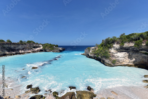 Blue Lagoon Nusa Ceningan is a cove filled with bright turquoise water and  popular spot among thrill seekers looking for cliff jumping © akturer