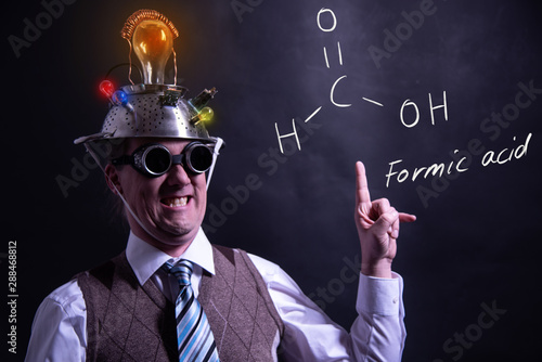 Nerd presenting handdrawn chemical formula of formic acid