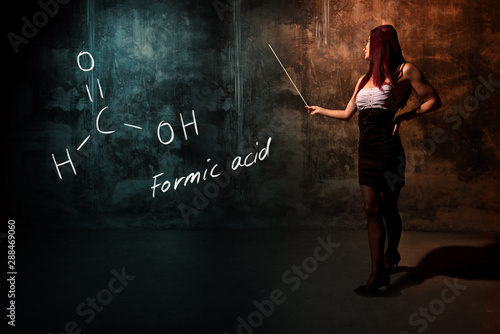 Fotografie Sexy girl or secretary or female student presenting handdrawn chemical formula o