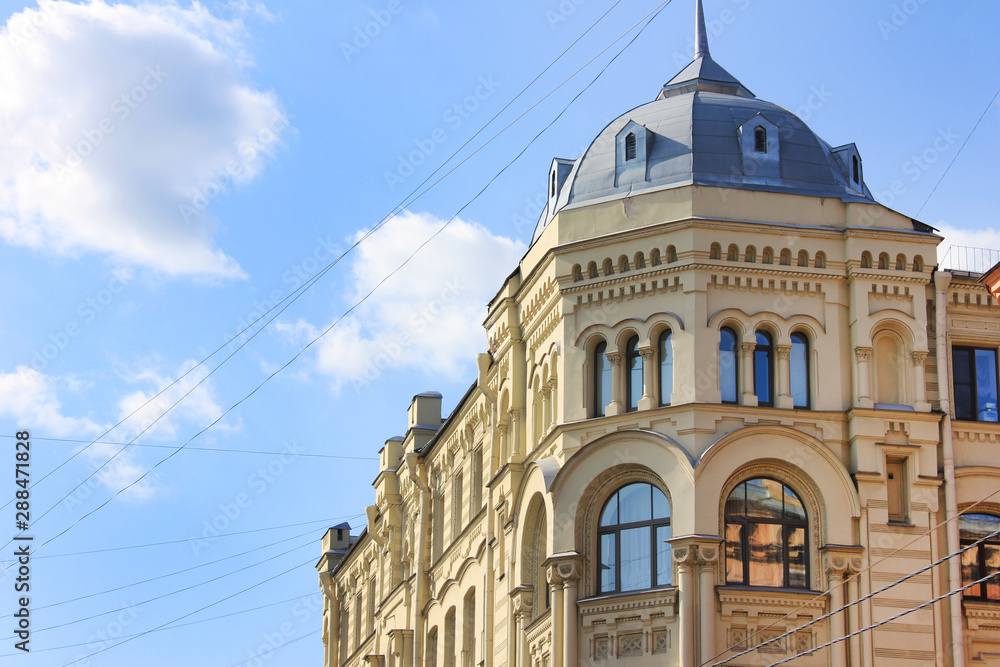 Building detail of classic russian architecture house in Saint Petersburg city center in Russia. Multi-storey loft style apartment house on sunny day 